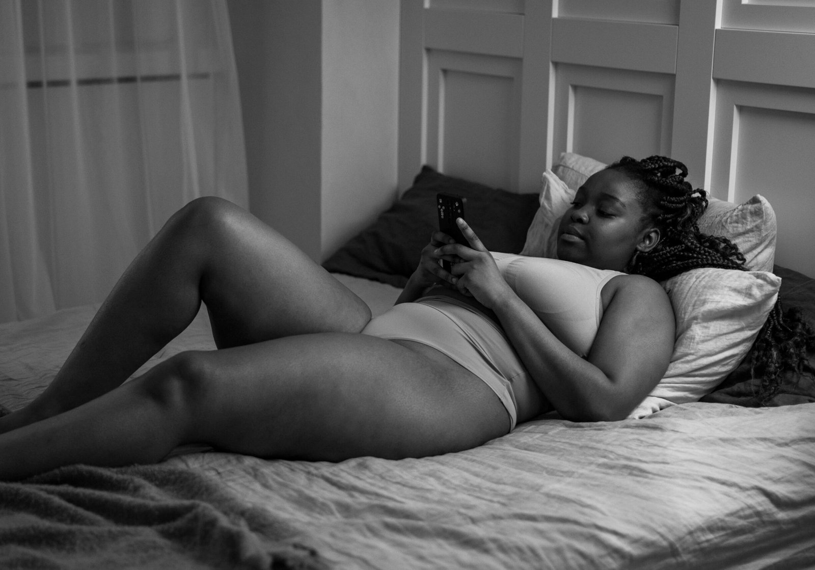 woman-with-smartphone-bed-full-shot